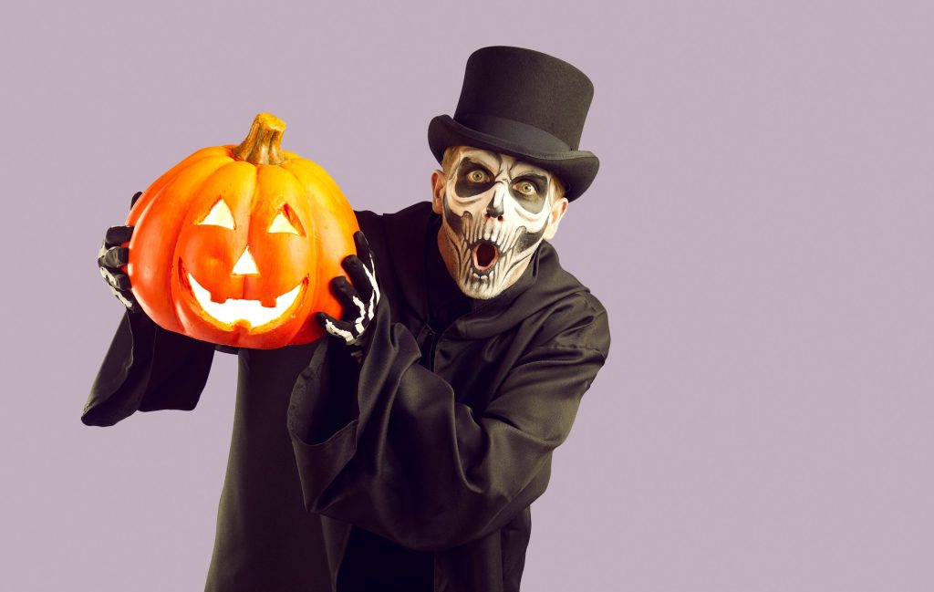 man,in,halloween,costume.,skeleton,in,black,cloak,and,top