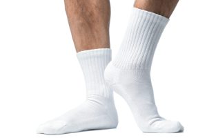 male,feet,with,white,cotton,socks,isolated,on,white,background